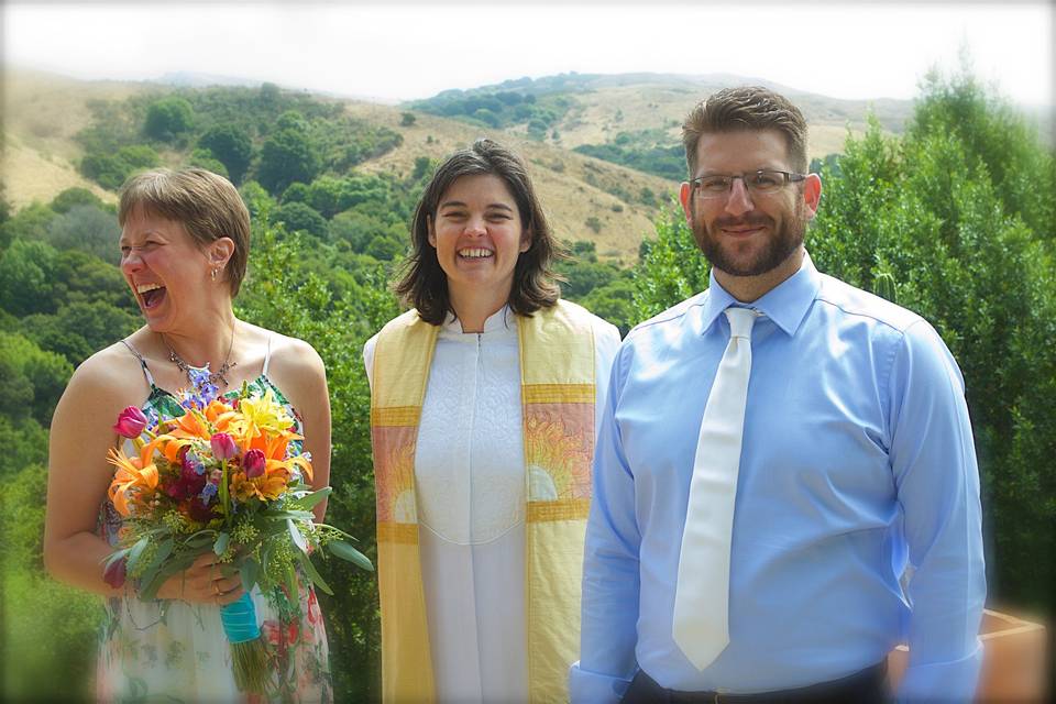 Newlywed couple and the officiant
