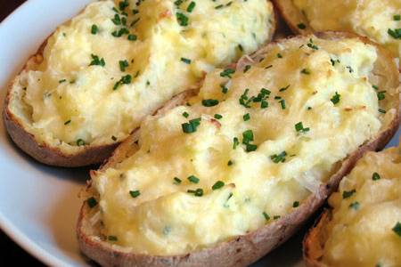 Twice baked potatoes with bacon, green onions & cheddar cheese