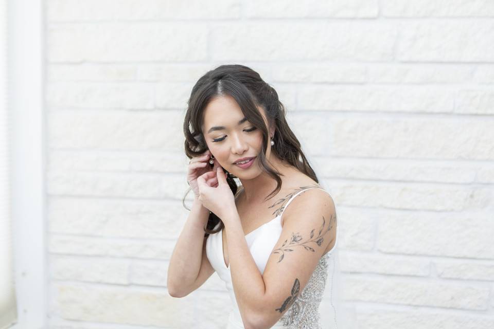 Bride Putting on Earrings