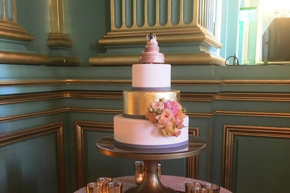 This blush and gold leaf wedding cake was finished with a vintage musical topper provided by the bride's grandparents.