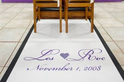 racing theme
thematic elements:  purple, black, and white, racing checks
custom aisle runner with Swarowsky crystal encrusted heart