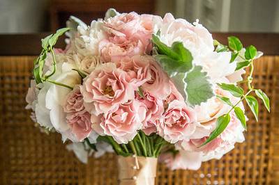 Beautiful and lush hand tied bridal bouquet of light pink peonies, blush peonies, light pink o'hara roses, candy bianca roses, keira garden roses, light pink spray roses, ivy, and accents of jasmine vines for a destination wedding on Oahu, Hawaii, at Lanikuhonua.  Bouquet by Passion Roots.  Photo by Frank J. Lee Photography.  #neuevents #neueventshawaii