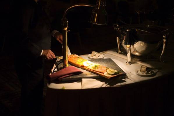 Server cutting salmon during Wedding Reception