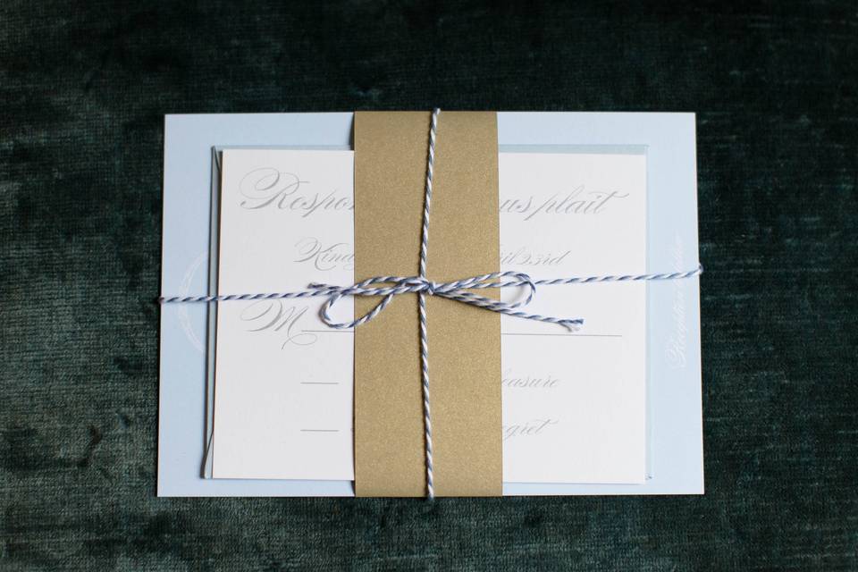 Blue, white and gold invitation suite with belly band and twine