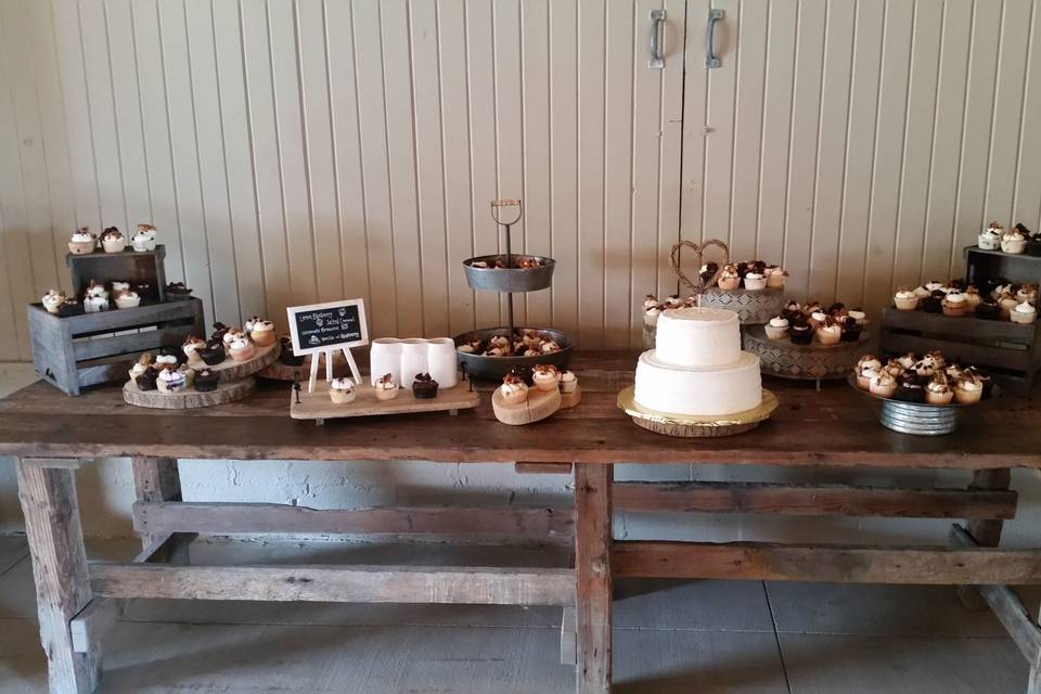 Cupcake spread and tiered wedding cake at jorgensen farms