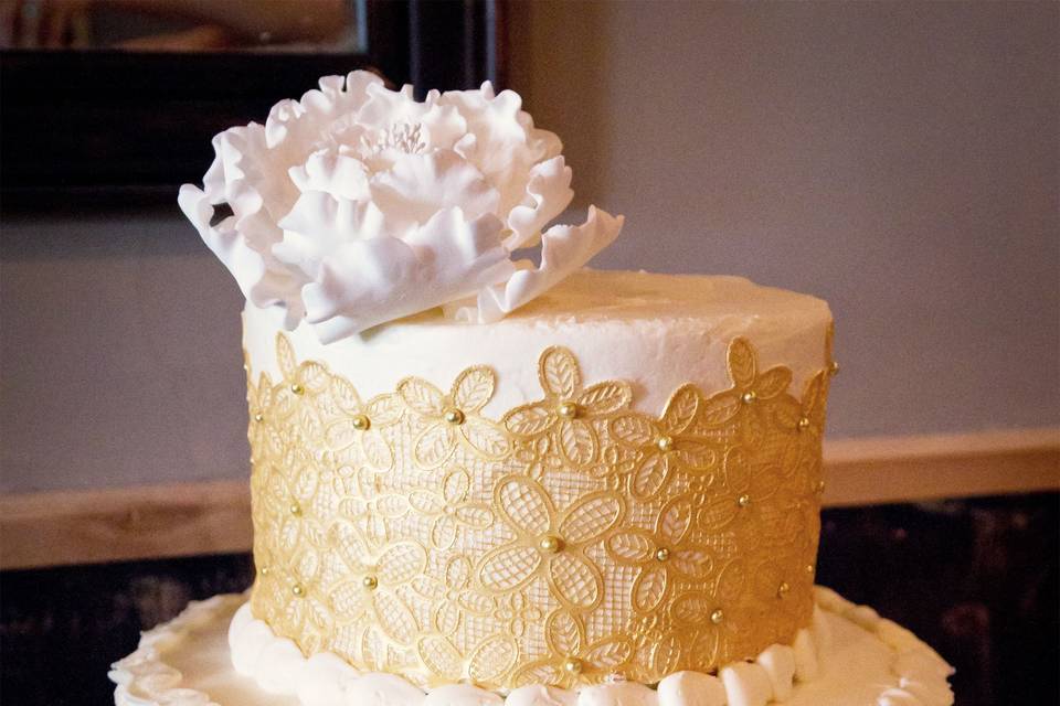 Gold lace and buttercream ruffle cake with peony topper at the wine bistro in westerville