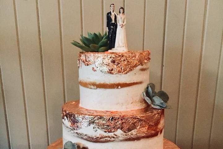 Rustic tiered wedding cake with edible copper accents