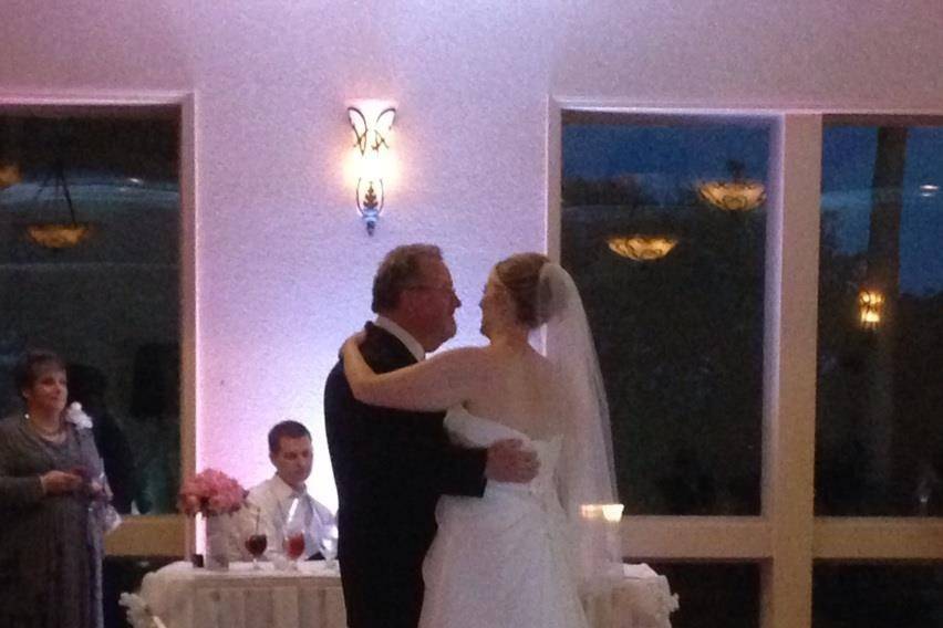 Father-Bride Dance at a wedding at Scenic Hills Country Club in Pensacola. You can see the custom monogram on the dance floor and white up lighting.