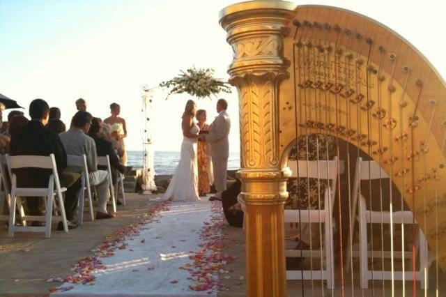 Harp music and and a late afternoon golden glow at a Faria Beach wedding.