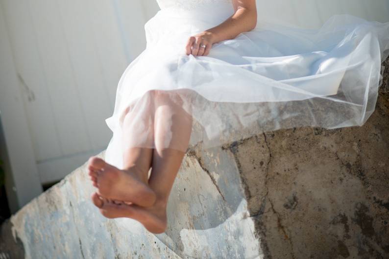 fun and free Hawaii beach setting with the bride alone, palm trees framing this beautiful Hawaiian Scene