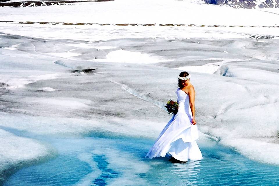 Bride Meredith plays in the Azure Glacier PoolPhoto by Becky McGill Mull of Azure Alaska Weddings.