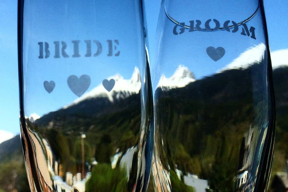 Customized Champagne Flutes for the Bride and Groom to take home.Photo By Kate McGill of Azure Alaska Weddings