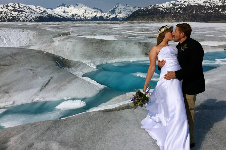 Mike kisses his bride.Photo by Becky McGill Mull of Azure Alaska Weddings.