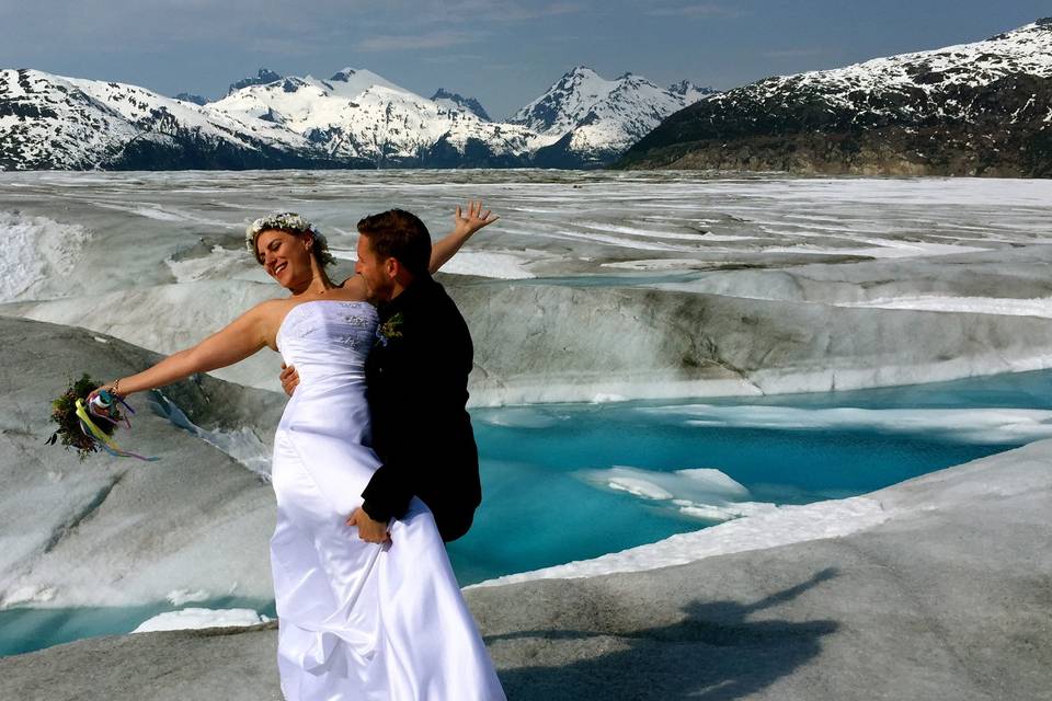 Meredith throws her arms out in joyful abandon. She's married her man!Photo by Becky McGill Mull of Azure Alaska Weddings.