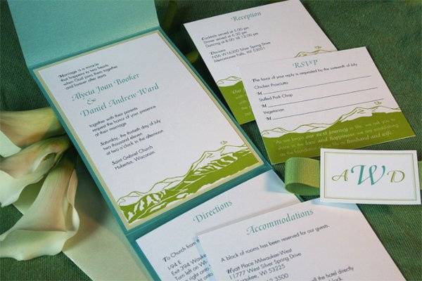 Blue and green pocket invitations with mountain landscape