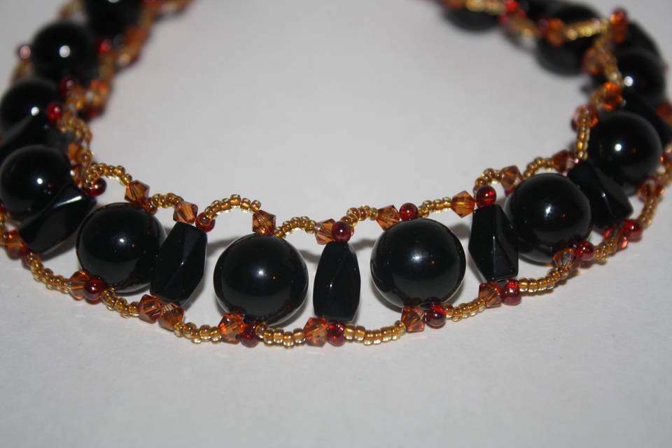 Custom design with unique combination of varying sizes of round& tube faceted black glass crystals with red and amber glass crystals in a beautiful beaded necklace, earrings and bracelet for the Bride or bridal party in any style and length,at affordable prices. All Renee needs is YOUR wedding colors.