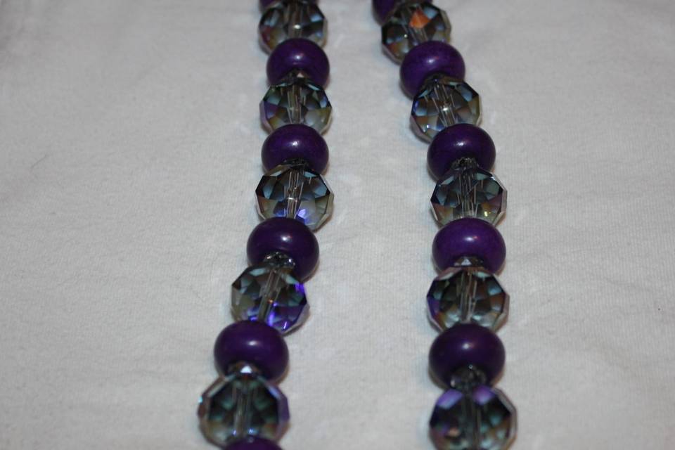 Custom design with unique combination of varying sizes of round faceted purple transparent and opague glass crystals in this beautiful beaded necklace, earrings and bracelet for the Bride or bridal party in any style and length,at affordable prices. All Renee needs is YOUR wedding colors.