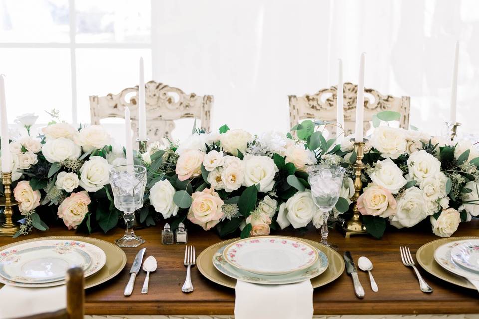 Head table with lots of flowers