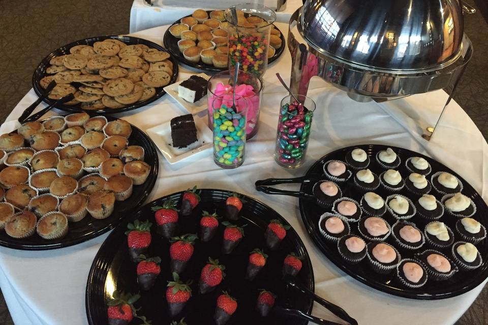 Assortment of Dessert Station. Chocolate Covered Strawberries, Petite Cheesecake Bites, Fresh Baked Cookies, Cupcakes and Muffins