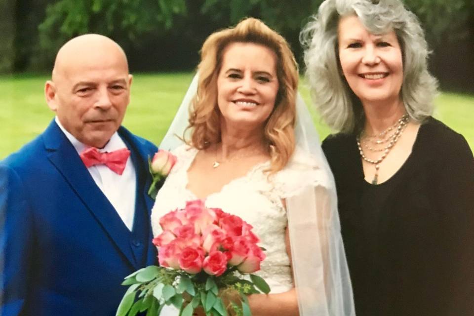 Groom and bride with the officiant