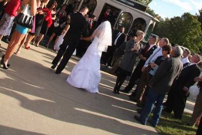 Newly married couple walking out to our Modern Trolley Limo!