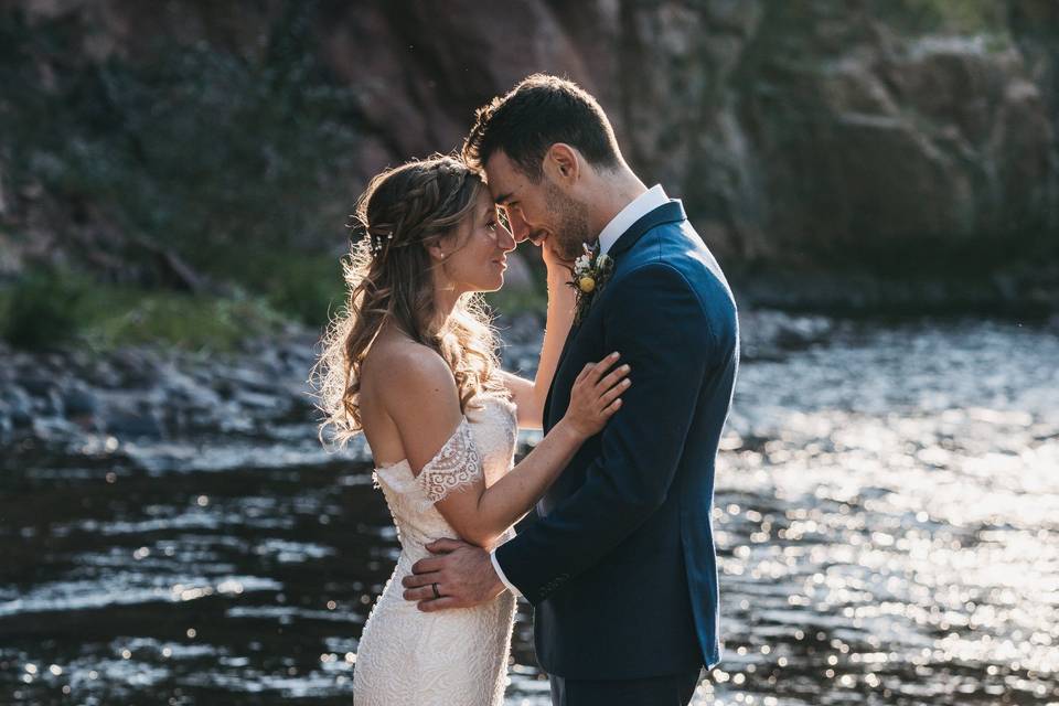 Bride and groom by water