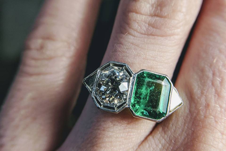 unique old european cut diamond and emerald two stone Edwardian engagement ring available at   Secrète Fine Jewelry in Washington, DC