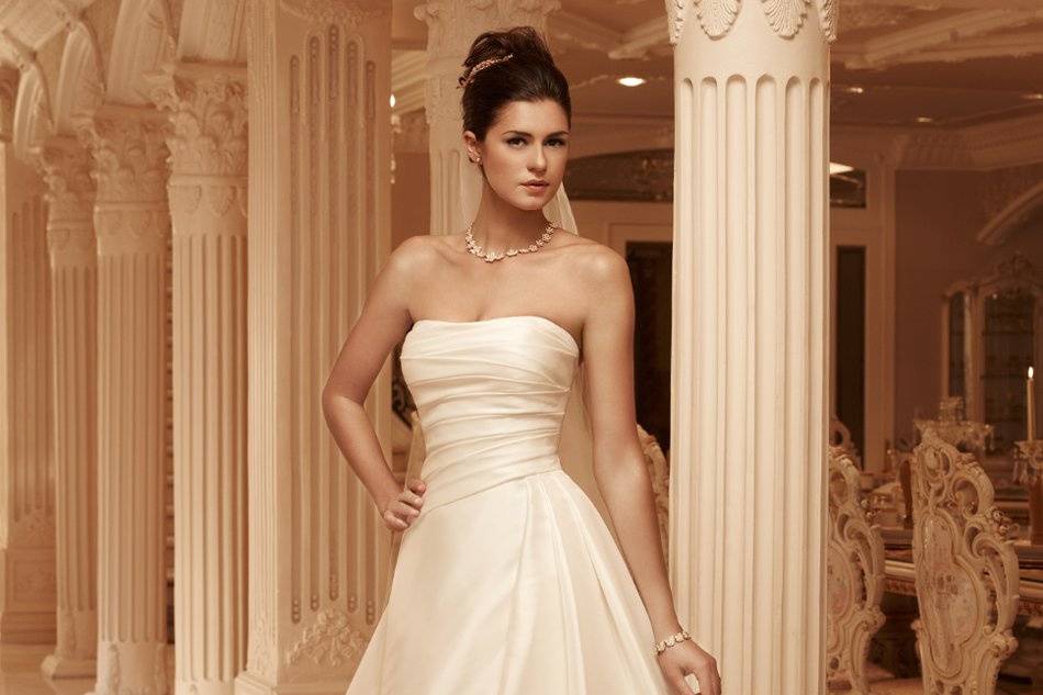 Style: 2101Textured Satin, strapless A-line gown with a sweetheart neckline. The bodice is pleated with an asymmetrical waist seam. Matching fabric buttons line the back of the gown.