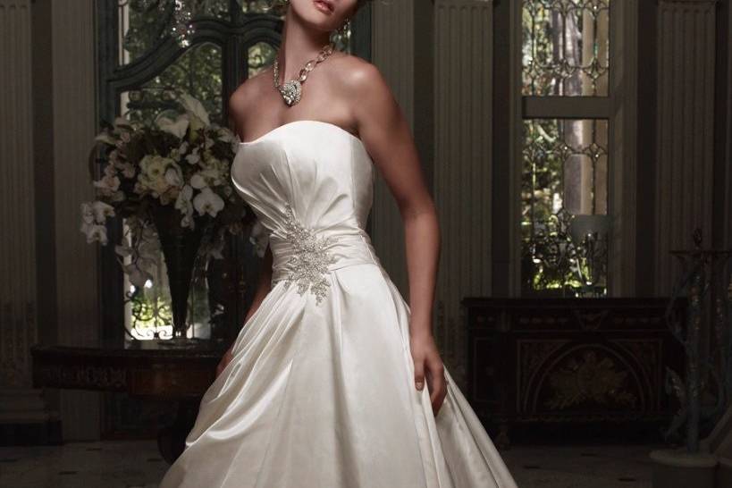 Style B028Silk Shantung gown with beaded lace embellished with Swarovski Crystals and crystal sequins. Neckline is straight across strapless, with fabric buttons from top to bottom, and an empire waist with an a-line skirt.