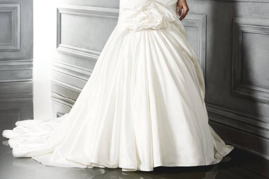 Style B042Duchesse Silk soft trumpet silhouette princess seamed gown with silver beaded accent on bust and a pleated crumb catcher at the front and back bodice.