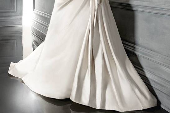 Style B020This Silk Shantung gown is for the fashion forward bride with its beautiful, hand-made flowers that come in a choice of plum or ivory. The flowers are tucked under each pick up of the gown, creating a fabulous design that is sure to make any bride stand out.