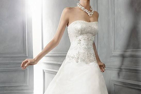 Style B047Silk Charmeuse ruched bust with a beaded and embroidered appliqué accenting the empire waist