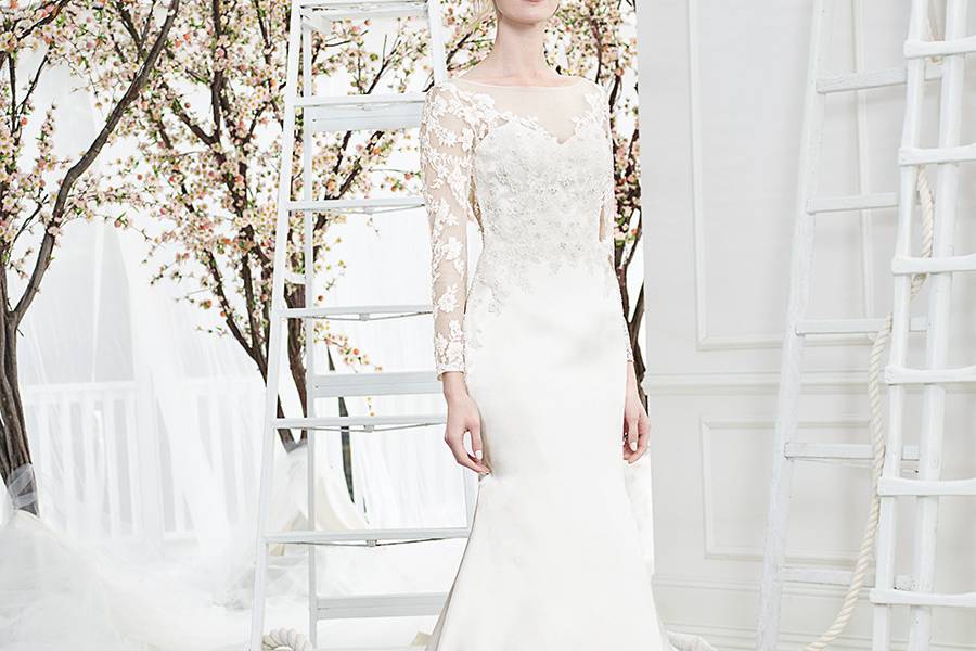 Style BL206 Joy  Joy has a bateau neckline outlined in hand beaded lace appliques that extend over dainty cap sleeves and down the gown’s sheer back. 