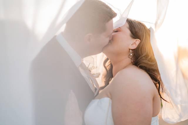 Bride and groom under veil