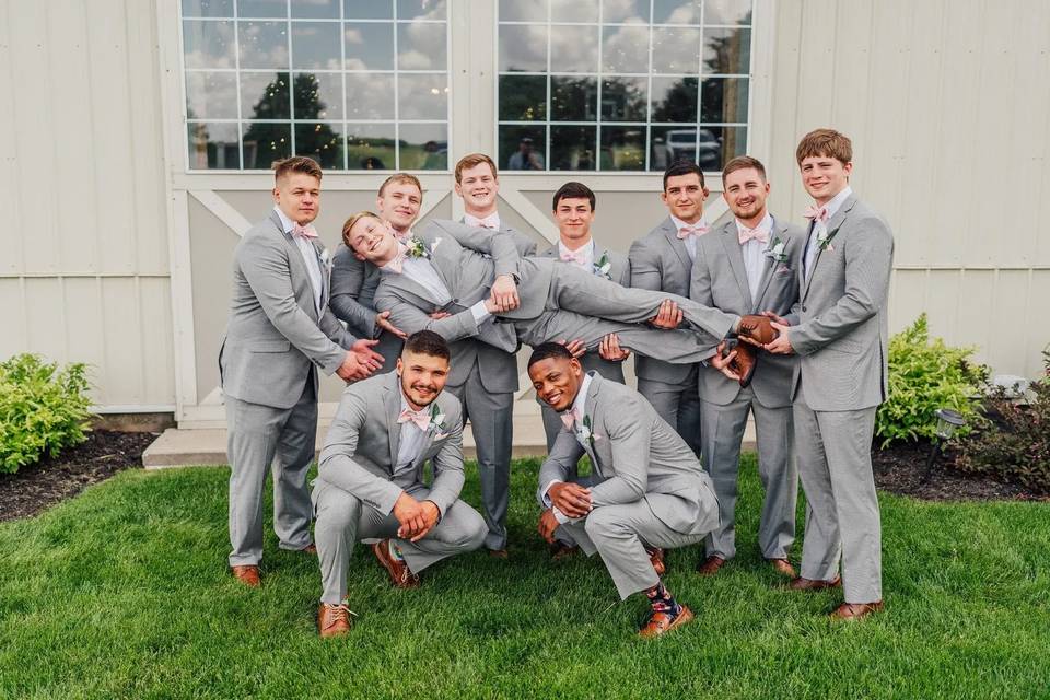 Groomsmen lifting groom