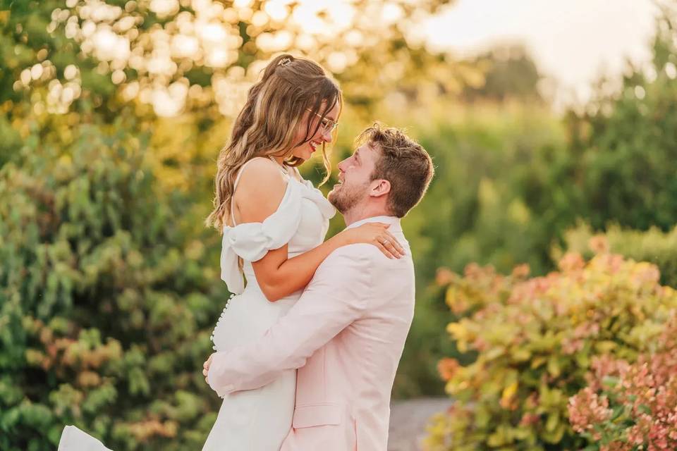 Groom lifting bride flowers