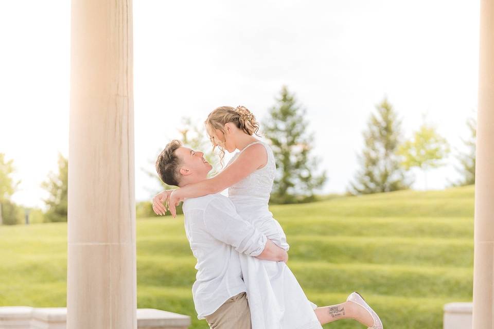 Groom lifting bride sunset
