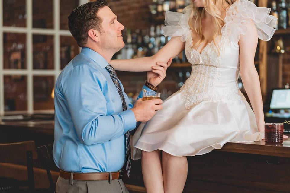Bride sitting on bar