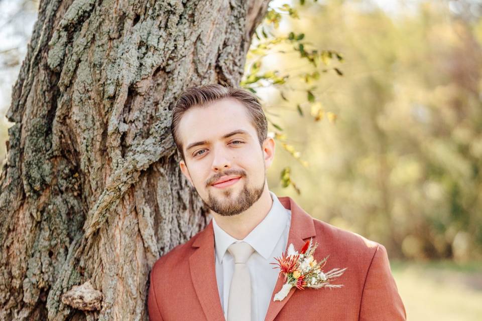 Groom standing at tree