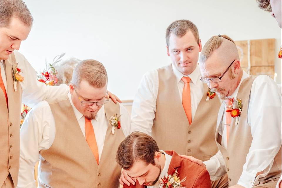 Groom and groomsmen praying