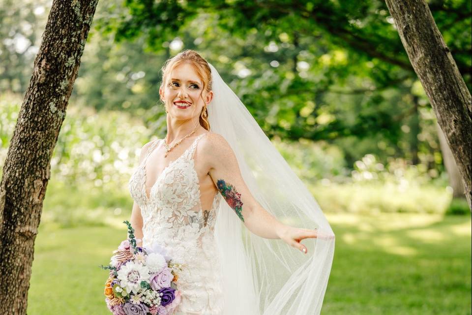 Bride under tree with dress