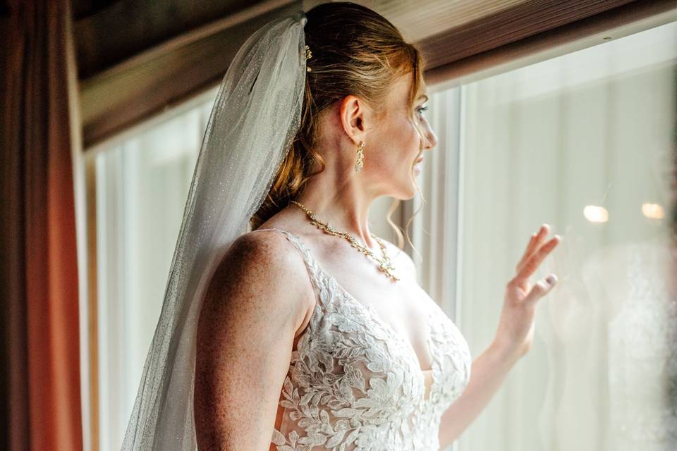 Bride looking out window