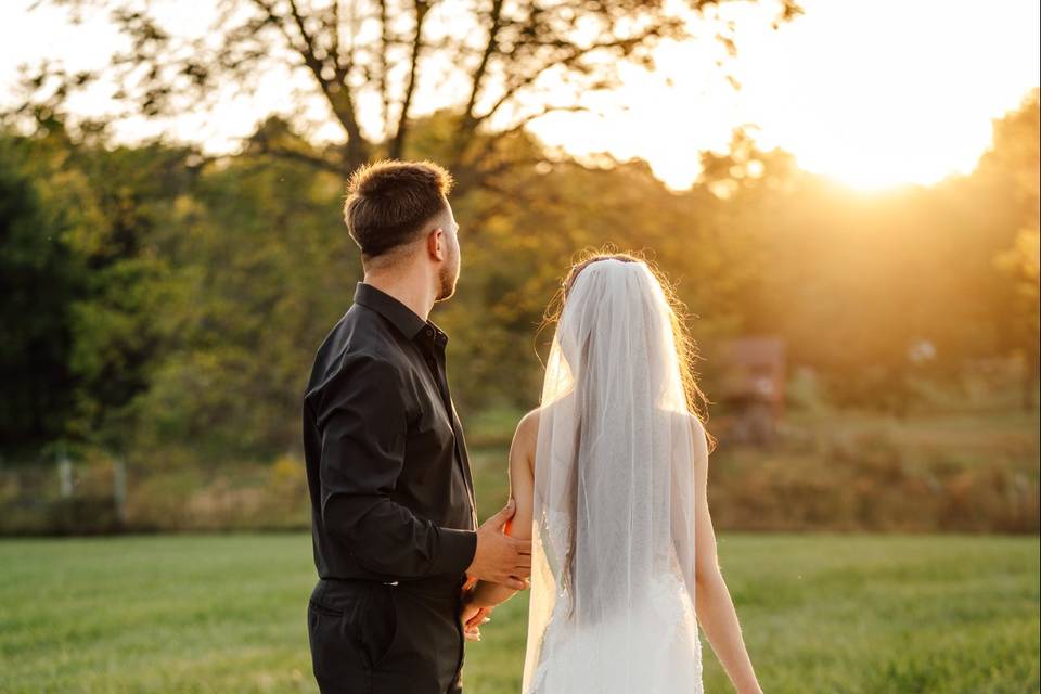 Bride and groom looking at sun