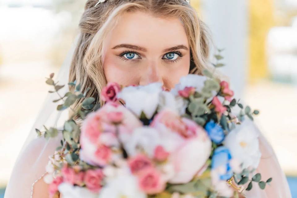 Bride behind flowers
