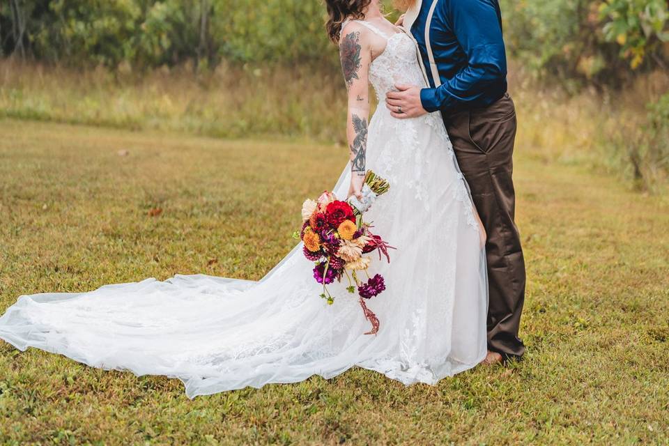 Bride and groom kiss in woods