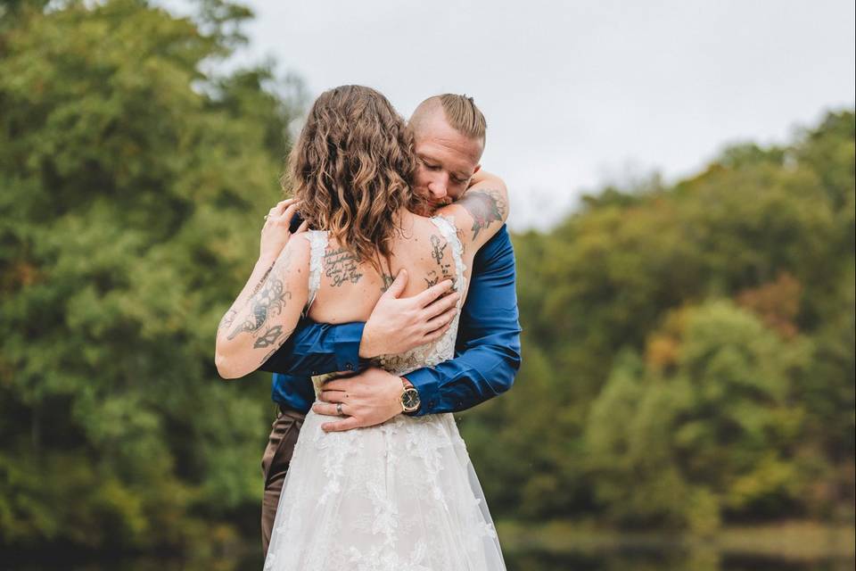 Groom hugging bride