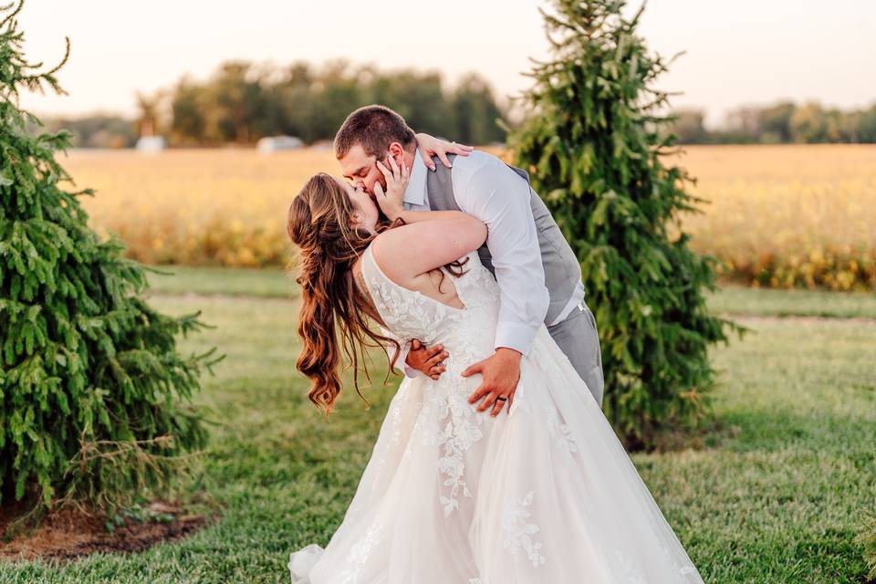 Bride and groom dipping kissin