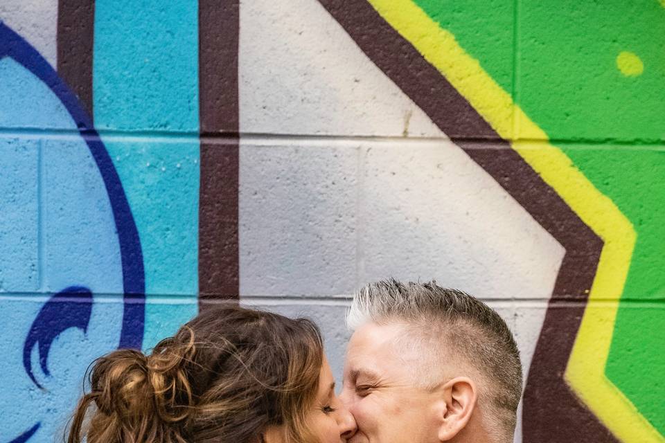 Couple in front of graffiti
