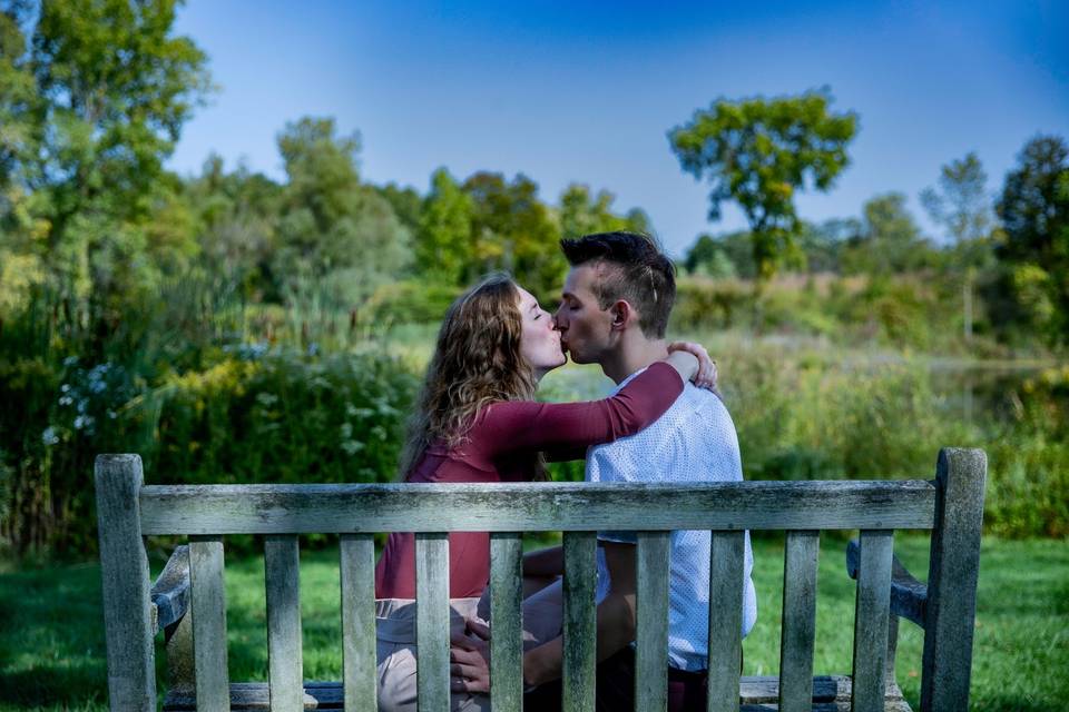 Couple kissing on bench