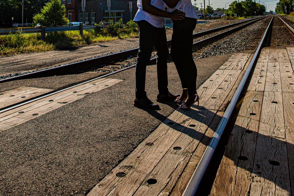 Engaged couple on train tracks